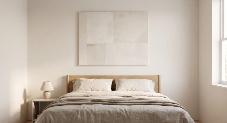 Calm bedroom with a soft low-contrast abstract artwork centred above a linen bed
