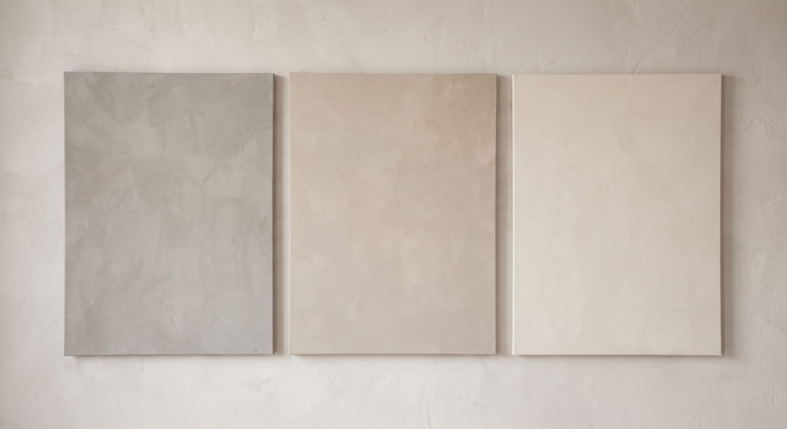 Three neutral artworks side by side in cool stone grey, warm beige and soft cream