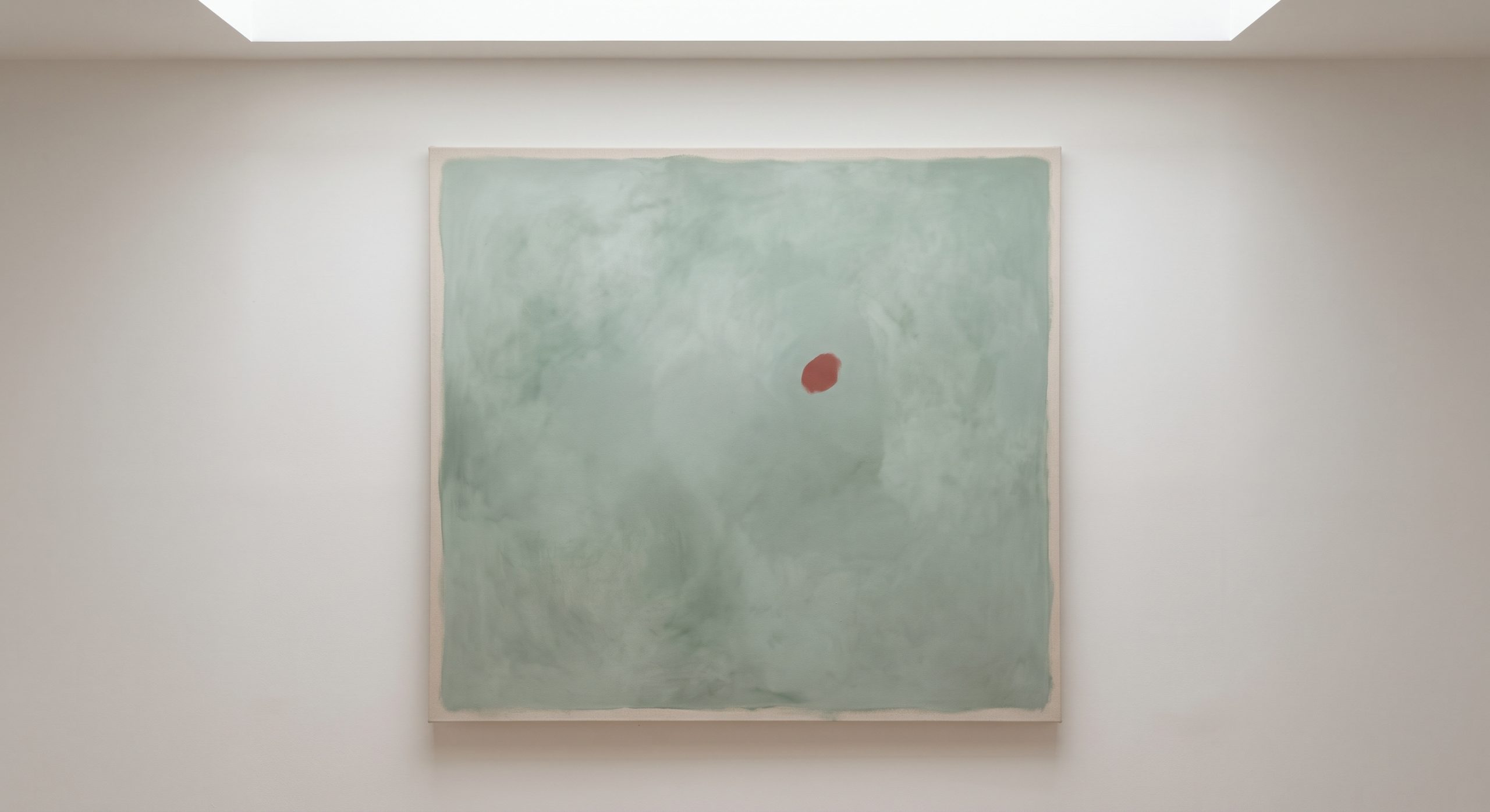 Abstract artwork with a small muted terracotta accent against a cool sage green ground
