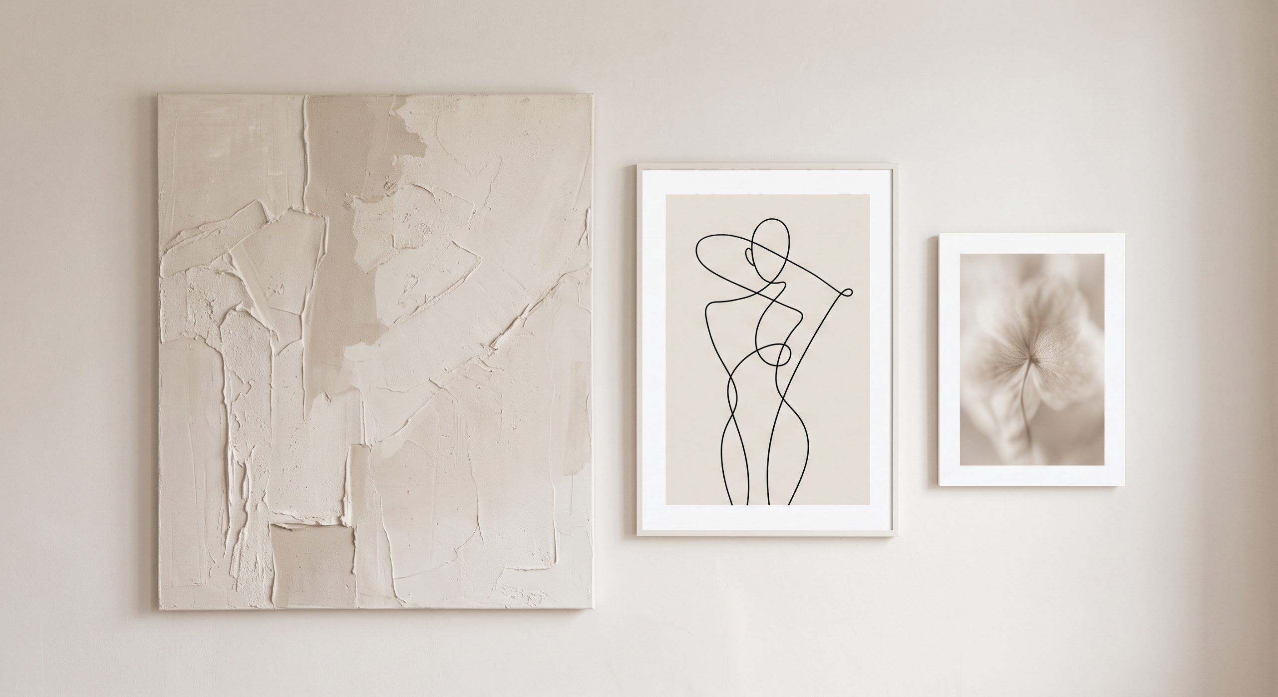Neutral gallery wall of four artworks in ivory, sand and taupe tones mixing texture, line and photography