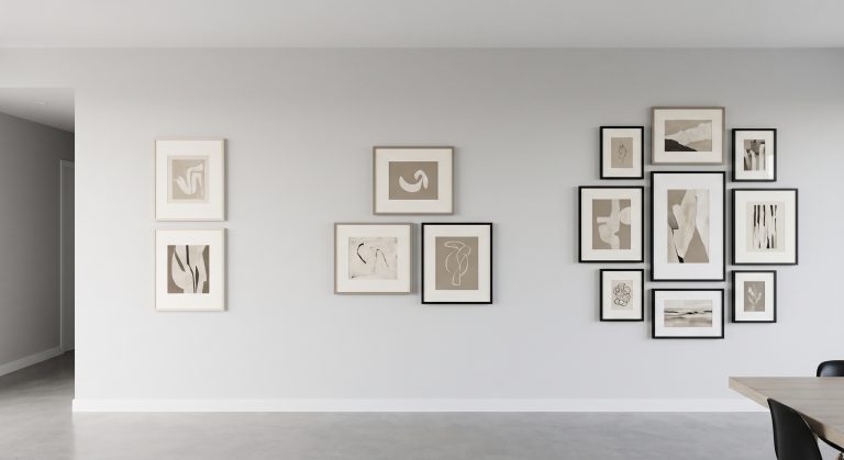 Three gallery wall groupings on one wall: a pair, a trio and a cluster of seven