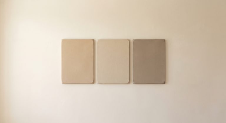 Minimalist artwork with a single fine horizontal line on a large ivory surface